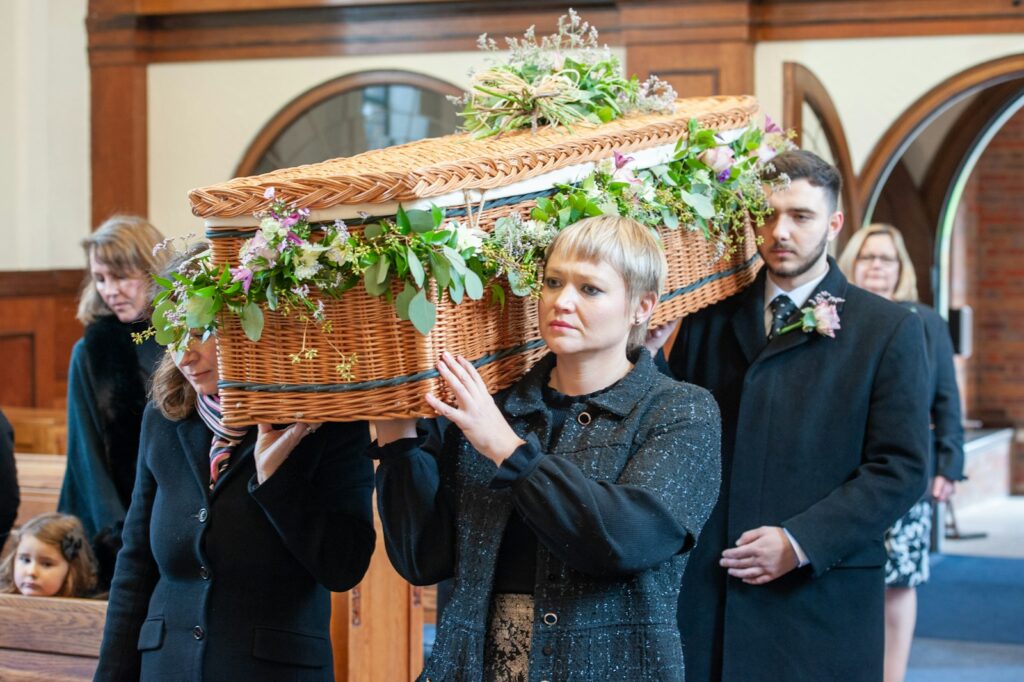 a woman holding a basket with flowers on it